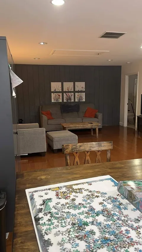 Living room with hardwood floors and a gray accent wall