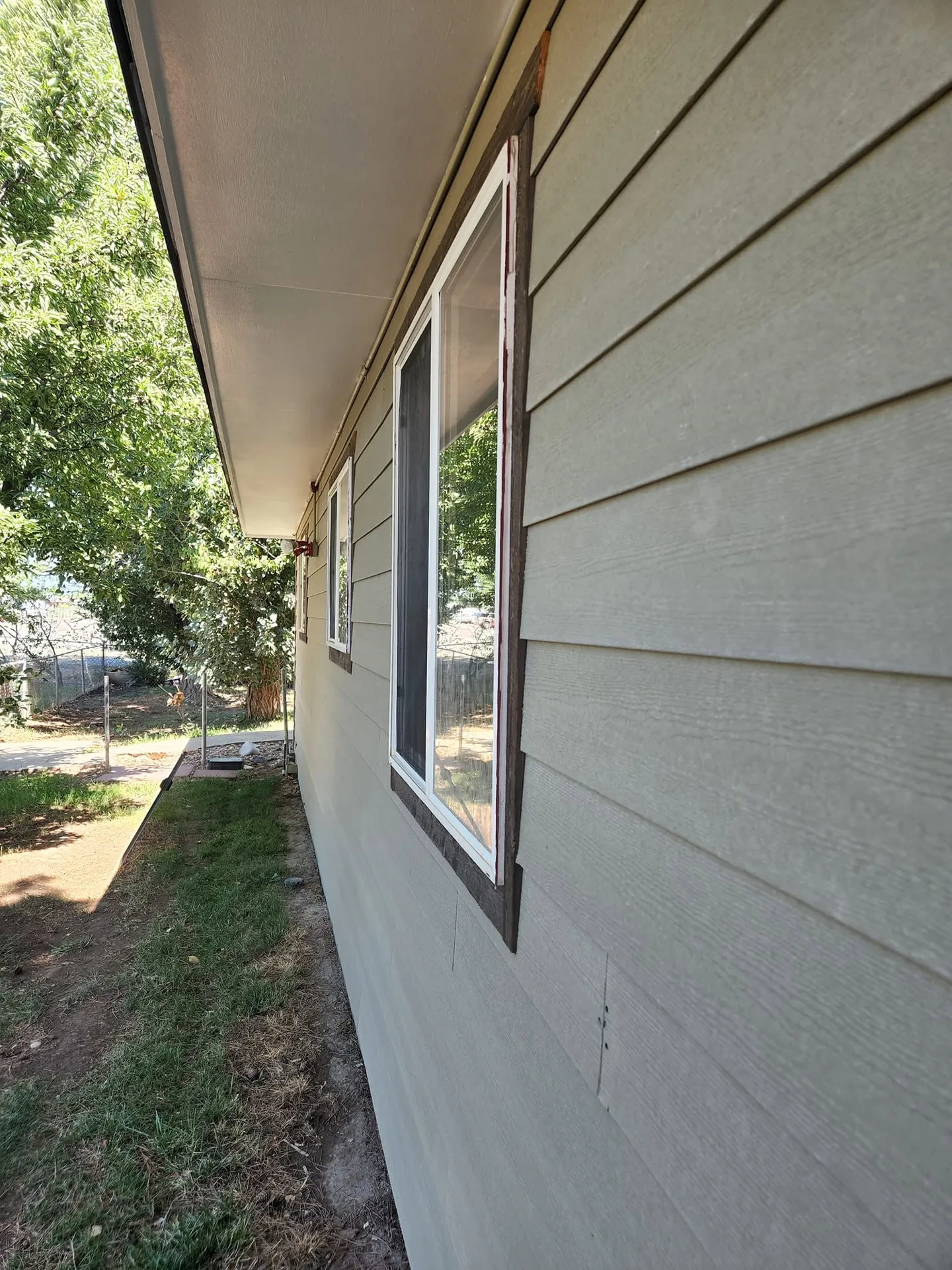 Long run of new lap siding along the side of a house